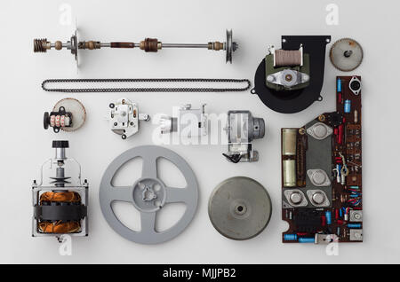 Parts of a vintage film projector well arranged over white background, above view. This is part of a larger series. Stock Photo