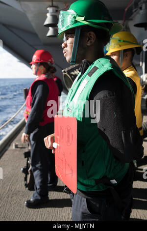 ATLANTIC OCEAN (Dec. 4, 2017) -- Boatswain's Mate 3rd Class Reginald Murphy, from Toledo, Ohio, assigned to USS Gerald R. Ford's (CVN 78) deck department, stands signalman watch during a replenishment-at-sea with USNS William McLean (T-AKE 12). Ford is currently underway conducting test and evaluation operations. (U.S. Navy photo by Mass Communication Specialist 3rd Class Gitte Schirrmacher) Stock Photo