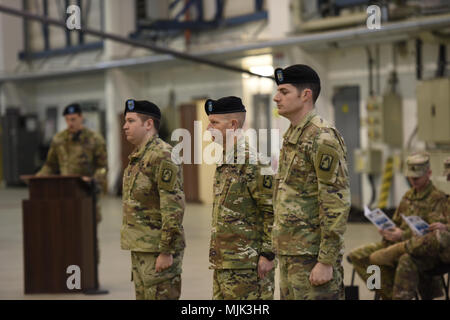 ANSBACH, Germany – Col. Kenneth Cole, 12th Combat Aviation Brigade (CAB) Commander presided over the Headquarters and Headquarters Company, 12th CAB Change of Command ceremony Wednesday, 12 December, 2017, on Katterbach Army Airfield. During the ceremony Cpt. William McGinnis relinquished command to Cpt. Charles Flanagan. (U.S. Army photo by Visual Information Specialist Eugen Warkentin) Stock Photo