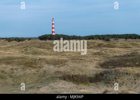 Lighthouse of the island Ameland in northern Netherlands with dunes on the foreground Stock Photo