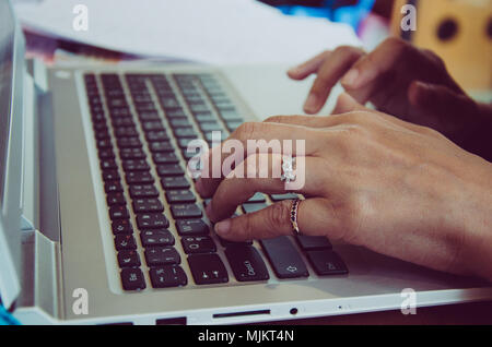 Woman office worker typing on the keyboard Stock Photo