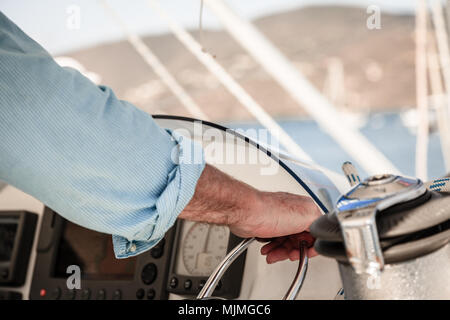 Close-up image of a man's hand on throttle control of a boat Stock Photo