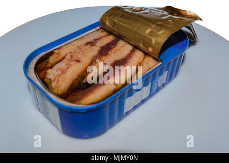Can of sardines on a white plate with a slice of bread. Stock Photo
