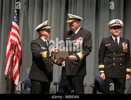 KEYPORT, Wash. (Dec. 15, 2017) Rear Adm. Daryl Caudle, left, commander, Submarine Force, U.S. Pacific Fleet, presents Rear Adm. John Tammen, from Washington Township, New Jersey, with his end of tour award during the change of command ceremony for Commander, Submarine Group 9. Rear Adm. Blake Converse, from Montoursville, Pennsylvania, relieved Tammen during the ceremony held at the Keyport Undersea Museum. (U.S. Navy photo by Mass Communication Specialist 1st Class Amanda R. Gray/Released) Stock Photo