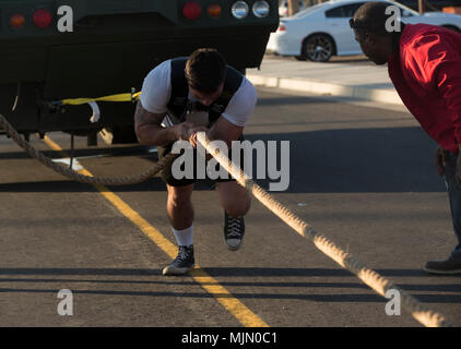 U.S. Marine Corps Cpl. Noah Diaz, an Aviation Ordnance Technician assigned to Marine Aviation Logistics Squadron 13, stationed at Marine Corps Air Station (MCAS) Yuma, Ariz., pulls a P-19R Aircraft Rescue and Firefighting vehicle to practice for the Strongman Competition Dec. 15, 2017 on the station parade deck. The practice is to prepare for the Bull of the Desert Strongman Competition slated Feb. 17, 2018 in Yuma, Ariz. (U.S. Marine Corps photo by Lance Cpl. Sabrina Candiaflores) Stock Photo