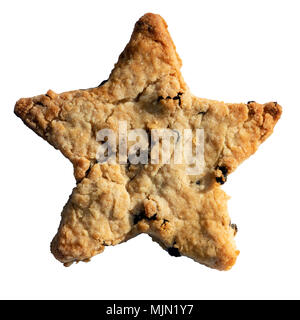 Home made biscuit with currants cut out in a star shape & isolated on a white background. Stock Photo