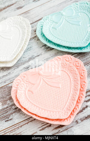 Set with empty heart shaped plates on white background Stock Photo - Alamy