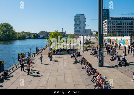 Berlin, Germany - may, 2018:  Many people at river Spree at Berlin Wall ( East Side Gallery) on a sunny day in Berlin, Germany Stock Photo