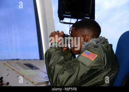 Kareem Bennett “glasses” the horizon March 16, 2018, from the 436th Operations Support Squadron air traffic control tower on Dover Air Force Base, Del. Bennett spent the day touring the installation with members of the 3rd Airlift Squadron as an honorary pilot for the day. Armed Forces and civilians displaying courage bravery dedication commitment and sacrifice Stock Photo