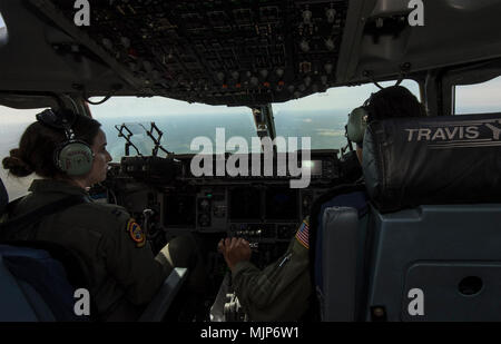 U.S. Air Force Capt. Victoria Nicholson and Capt. Nichole Evans pilots with the 21st Airlift Squadron, make final approach to a an undisclosed position in the Pacific region during a Women’s Heritage Flight, March 19, 2018. An all-female C-17 Globemaster III crew conducted the mission that displayed pride in their heritage and showcased their ability to conduct rapid global mobility in today’s Air Force by transporting equipment and military passengers to Pacific Command area of responsibility. Armed Forces and civilians displaying courage bravery dedication commitment and sacrifice Stock Photo