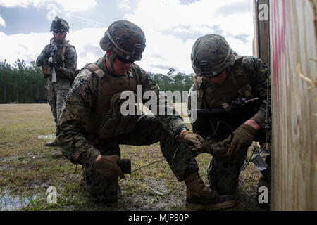 U.S. Marines from different units construct an oval charge during an ...