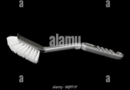 Grey  dish  brush isolated on black background. Stock Photo