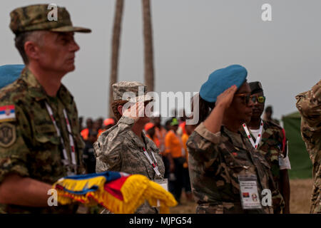 Lt. Col. Jill McLoughlin, a preventative medicine officer with the Ohio Army National Guard, represents the U.S. in the exchanging of flags during the closing ceremony for the PAMBALA 2017 exercise Dec. 14, 2017, in Bengo Province, Angola. Personnel from the Serbian Armed Forces and the Ohio National Guard exchanged flags with their host nation, the Republic of Angola, and remarks were given by representatives of each participating country on the success of the first-ever engagement. (Ohio National Guard photo by Staff Sgt. Wendy Kuhn) Stock Photo