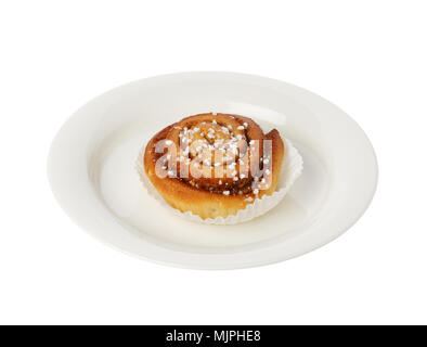 Cinnamon bun on a small plate isolated on white. Stock Photo
