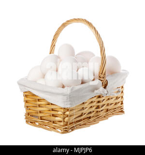 A large group of hen eggs collected in a basket with handle isolated on white background. Stock Photo
