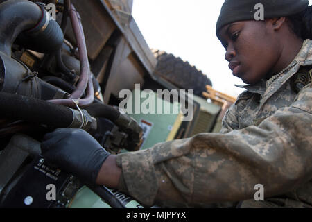 U.S. Army Pfc. Kiersten Letang a Multiple Launch Rocket System (MLRS) repairer with B Battery, 1st Battalion, 38th Field Artillery Regiment, 2nd Infantry Division/ROK-US works on an M993 Carrier Vehicle in South Korea, Dec. 8, 2017. Repairers are trained to quickly troubleshoot and fix the MLRS in any enviroment to ensure mission readiness at all times. (U.S. Army photo by Staff Sgt. Carl Greenwell) Stock Photo