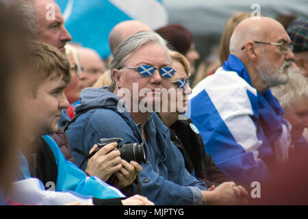 Glasgow, Scotland, UK. 5th May, 2018. March for Independence has taken place in Glasgow, with demonstrators travelling from Kelvingrove Park, through the West End and into the city centre, and finally arriving at Glasgow Green, where there was a stage with political speakers and entertainment. People of all ages were draped in Saltires and waving their flags. According to Police Scotland, an estimated 35,000 pro-Indy supporters took part. The organisers, All Under One Banner (AUOB), claim an even higher figure. Iain McGuinness / Alamy Live News Stock Photo