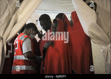 Malaga, Spain. 6th May, 2018. A migrant who was rescued from a dinghy in the Mediterranean Sea, looks at camera inside a tent of Spanish Red Cross as he is assisted after his arrival at Port of Malaga. Members of the Spanish Maritime Safety rescued in this early morning a total of 110 migrants from two boats near the Malaga coast. Credit: Jesus Merida/SOPA Images/ZUMA Wire/Alamy Live News Stock Photo
