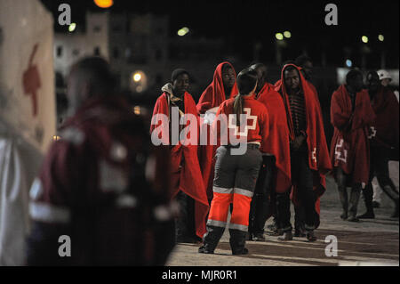 Malaga, Spain. 6th May, 2018. Migrants who were rescued from a dinghy in the Mediterranean Sea wait after their arrival at Port of Malaga. Members of the Spanish Maritime Safety rescued in this early morning a total of 110 migrants from two boats near the Malaga coast. Credit: Jesus Merida/SOPA Images/ZUMA Wire/Alamy Live News Stock Photo