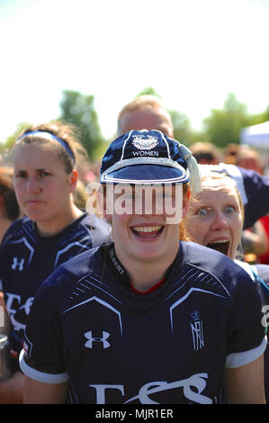 London, UK, 5 May 2018. Emily Howard (SLt, Royal Navy) wearing a match cap while team mates lark about in the background at the end of the annual women’s annual inter-service competition match at Kneller Hall, London, UK.  The match was won by the British Army, 72-3.    In 2003 a Women’s Inter-Service Competition was introduced to run alongside the men’s competition. The inaugural competition wa Credit: Michael Preston/Alamy Live News Stock Photo