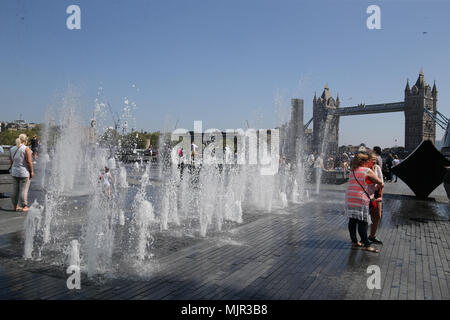 London UK 06 May 2018 a Lovely sunny day in the capital saw thousands of people enjoying the water fountains overlooking Tower bridge t@Paul Quezada-Neiman/Alamy Live News Stock Photo