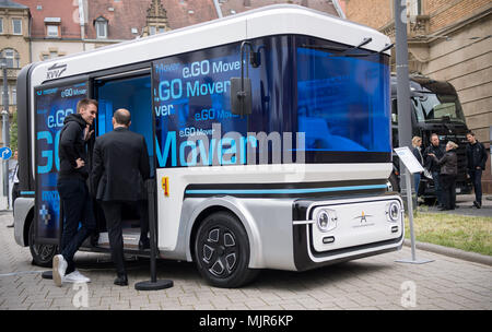 03 May 2018, Karlsruhe, Germany: Visitors looking at the autonomous driving mini bus 'e.Go mover' during the opening of the 'Test field of autonomous driving'. The tesfield will explore the possibilities of driverless cars on selected routes between Karlsruhe, Bruchsal and Heilbronn. Photo: Sebastian Gollnow/dpa Stock Photo