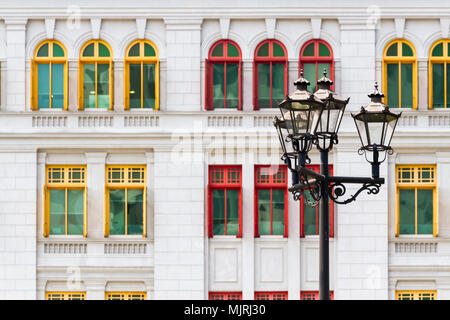 Colourful windows of the Old Hill Street Police Station, Singapore, with a black old fashioned street light in front Stock Photo