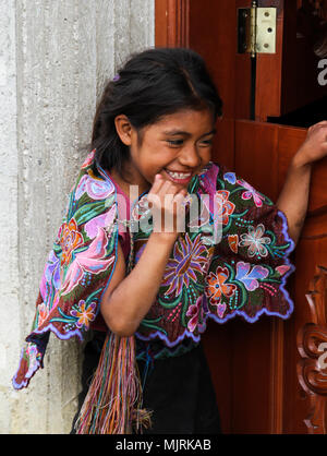 Zinacantan, Mexico - November 8, 2013: A young indigenous Tzotzil Maya girl smiling outside her home in a rural village near San Cristobal de la Casas Stock Photo