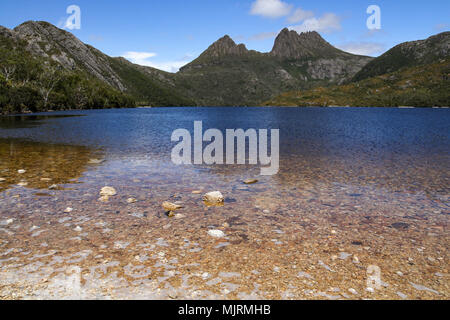 Cradle Mountain, a popular Tasmanian tourist destination, with Dove Lake in the foreground and alpine vegetation Stock Photo