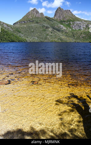 Cradle Mountain, a popular Tasmanian tourist destination, with Dove Lake in the foreground and alpine vegetation Stock Photo