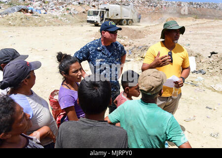 PUERTO CORTES, Honduras (March 21, 2018) Chaplain Michael Vitcavich speaks with Honduran locals at the city's landfill during Continuing Promise 2018. U.S. Naval Forces Southern Command/U.S. 4th Fleet has deployed a force to execute Continuing Promise to conduct civil-military operations including humanitarian assistance, training engagements, and medical, dental, and veterinary support in an effort to show U.S. support and commitment to Central and South America. Armed Forces and civilians displaying courage bravery dedication commitment and sacrifice Stock Photo