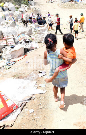 PUERTO CORTES, Honduras (March 21, 2018) Honduran children walk through garbage at the city's landfill during Continuing Promise 2018. U.S. Naval Forces Southern Command/U.S. 4th Fleet has deployed a force to execute Continuing Promise to conduct civil-military operations including humanitarian assistance, training engagements, and medical, dental, and veterinary support in an effort to show U.S. support and commitment to Central and South America. Armed Forces and civilians displaying courage bravery dedication commitment and sacrifice Stock Photo