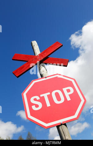 Swedish stop sign before snowmobile trail crossing the road. Stock Photo