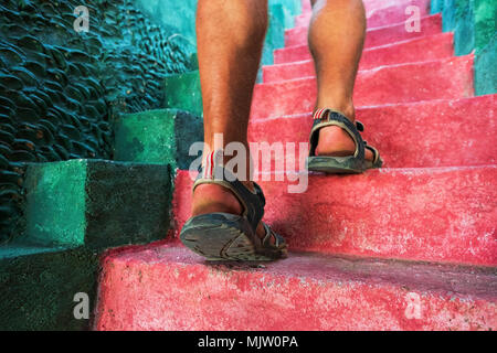 Walking green upstairs in summer: close-up view of man legs. Stock Photo