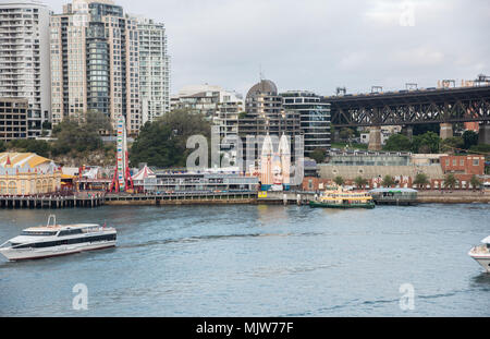 Sydney,NSW,Australia-December 7,2016: Luna Park, nautical vessels and urban architecture at twilight in Sydney, Australia Stock Photo