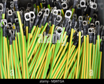 Bundle of electric cables with attached connectors ready for use on the assembly line in a factory during the manufacturing process Stock Photo