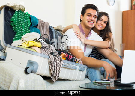 Smiling couple preparing for honeymoon and making planning list Stock Photo