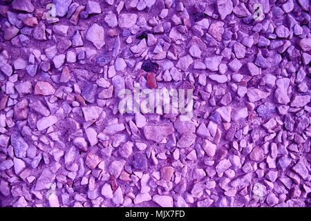 Ultra purple Pebble textured surface, stone backdrop and boulder background. Stock Photo