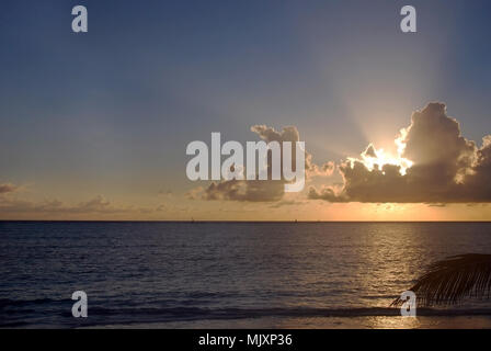 The sun sets behind the clouds in Zanzibar Stock Photo