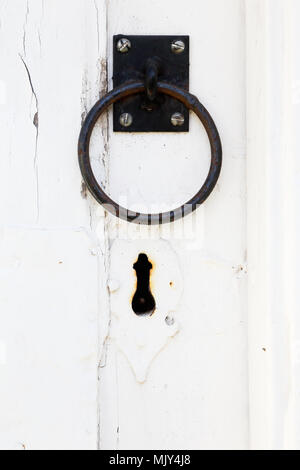 Close up of black handle and keyhole on a white door. Stock Photo
