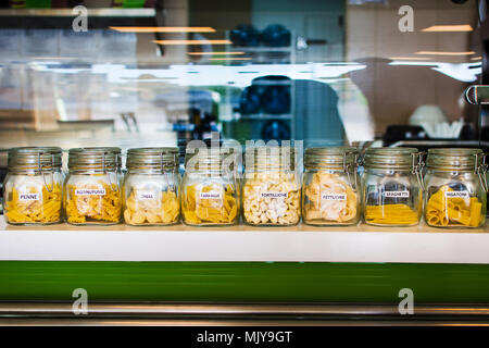 Various raw pasta selection in labeled jars Stock Photo