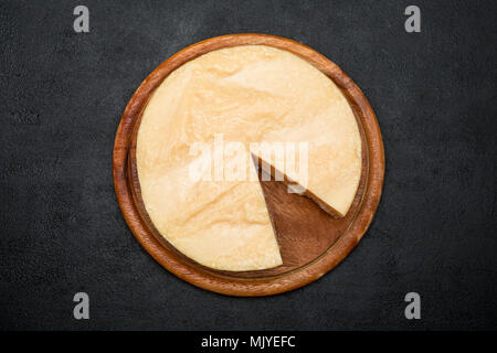 Whole round Head and pieces of parmesan or parmigiano Stock Photo