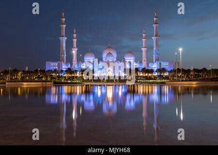 Sheikh Zayed Grand Mosque in Abu Dhabi, capital city of the United Arab Emirates. Mosque is built from Italian white marble. Reflection in lake Stock Photo