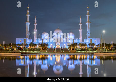 Sheikh Zayed Grand Mosque in Abu Dhabi, capital city of the United Arab Emirates. Mosque is built from Italian white marble. Reflection in lake Stock Photo