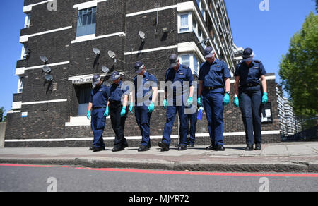 A police search team at the scene ouside Aberfeldy House in Camberwell New Road, Southwark, south London, as 17-year-old Rhyhiem Ainsworth Barton was shot dead in Warham Street on Saturday evening after officers were called to reports of gunshots on nearby Cooks Road. Stock Photo