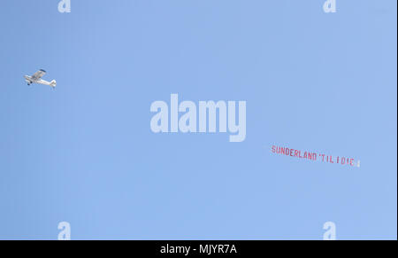 A plane flies over the stadium with a banner reading 'Sunderland 'Til I Die' during the Sky Bet Championship match at the Stadium of Light, Sunderland. Stock Photo