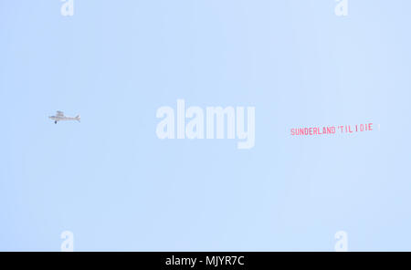 A plane flies over the stadium with a banner reading 'Sunderland 'Til I Die' during the Sky Bet Championship match at the Stadium of Light, Sunderland. Stock Photo