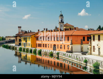 Cityscape of Gaggiano, just outside of Milan. Colourful houses reflected in the Naviglio Grande canal waterway Stock Photo