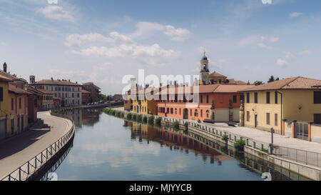 Cityscape of Gaggiano, just outside of Milan. Colourful houses reflected in the Naviglio Grande canal waterway Stock Photo