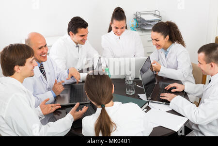 Team of professional medics and head physician at seminar in clinic Stock Photo